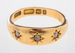 A Victorian gold ring with three small rose cut diamonds in gypsy setting, Birmingham 1898,