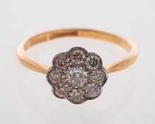 A diamond flower head cluster ring in 18ct gold,