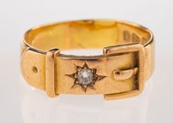 A gold and diamond buckle ring, the buckle ring set with an old cut diamond,