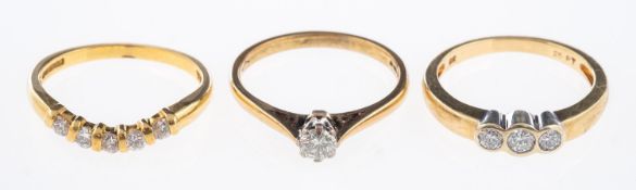 Three diamond set rings, an 18ct gold ring set with five diamonds, total diamond weight 0.
