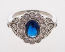 A dress ring set with diamonds and synthetic sapphire in millgrain white gold setting,