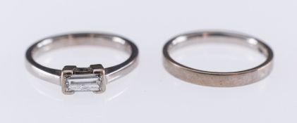 A white gold ring set with a baguette form diamond, in 18ct,