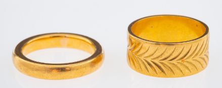A gold wedding band with chevron pattern leaf decoration, and a plain wedding ring both 22ct,