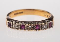 A ruby and diamond ring, half set with circular cut rubies and eight cut diamonds,