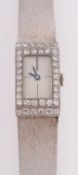 A platinum and 18ct white gold and diamond ladies wrist watch the rectangular dial with baton