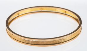 A 1920's flapper girl arm bangle, with three bands the central with engine turned decoration,