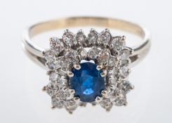 A sapphire and diamond cluster dress ring, central mid blue sapphire, 7 x 5 mm,