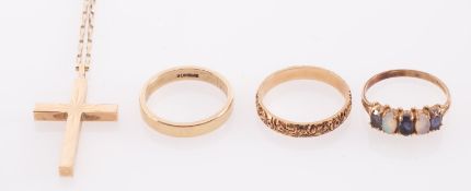 A gold ring set with opal and sapphire, a wedding band with flowers in relief,