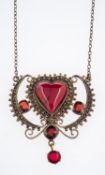 An early 20th Century Scandinavian filigree silver gilt pendant set with heart form and faceted