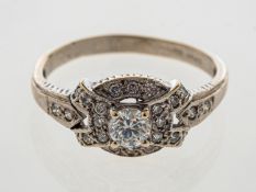 A diamond cluster ring set in 18ct white gold, central stone estimated at 0.
