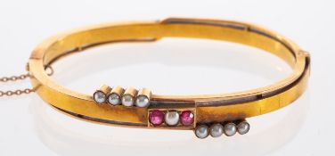A Russian synthetic ruby and split pearl hinged bangle,