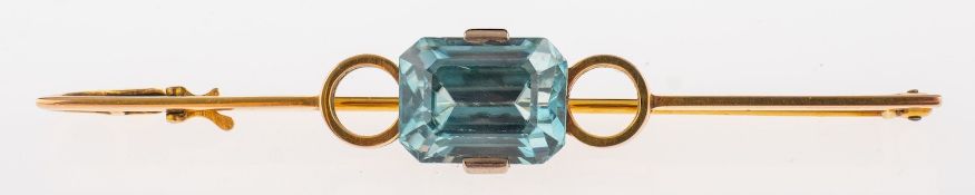 A blue zircon set bar brooch the step cut stone bordered by gold circles, C1940, 4.