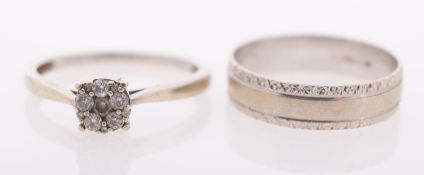 Two white gold rings, a diamond cluster ring, and a gold band with relief decoration, both 9ct gold,