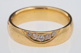 Nuran Denmark, a contemporary gold band ring with wave design inset with diamonds, 14 ct gold,