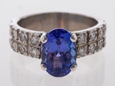 A tanzanite & diamond ring set with an oval faceted stone of around 2.