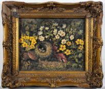 Bird's nest surrounded by flowers.