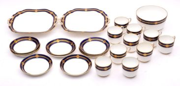 A Minton porcelain part tea service decorated with a gilt and cobalt blue band,
