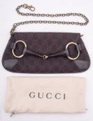 A Gucci brown leather and monogrammed canvas horse bit evening clutch bag,