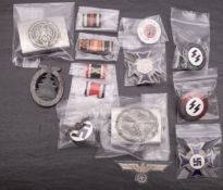 A collection of German military badges, ribbon bars, and buckles etc.