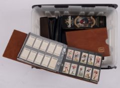 Cigarette and trade cards, an accumulation of sets and part sets in eight albums and loose in a tin,