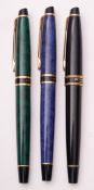 A group of three Waterman Expert fountain pens, in blue, green and black finish.
