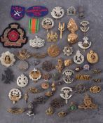 A collection of British Regimental cap and lapel badges etc.