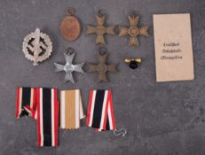 A group of four WWII German War Merit Crosses, together with a West Wall Medal,