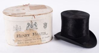 A black silk top hat, maker Lincoln Bennett & Co, London, 52.5cm, in a Henry heath card hat box.