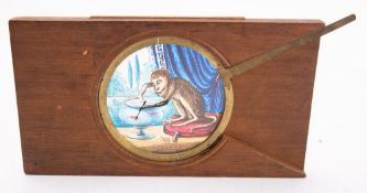 A 19th Century magic lantern lever slide of a monkey with a fork over a fish bowl, unsigned,