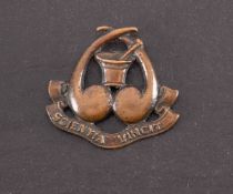 A WWI Pharmacists Corps bronze cap badge,