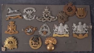 A collection of fourteen various regimental cap badges, including ' 5th VB Manchester',