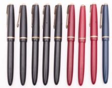 A group of nine Parker Slimfold fountain pens, consisting of one blue, three maroon and five black.
