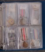 A collection of reproduction medals in a Medal Album.