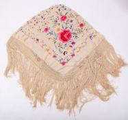 An ivory silk shawl with polychrome floral embroidery,