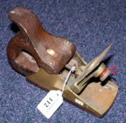 An unsigned brass and rosewood scraper with shaped handle, 19cm (7 1/2 inches).