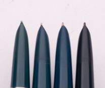 A group of four Parker 51 fountain pens, blue/grey barrel with sliver plated caps.