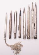 A group of eight various silver plated propelling pencils, including three advertising examples.