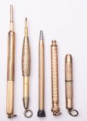A group of five late 19th/early 20th century gold plated propelling pencils.
