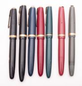 A group of seven Parker Duofold fountain pens,consisting of two black, two maroon, one grey,