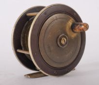 A bakelite and brass salmon fly reel, retailed by Prickman Exeter, 4inch, brass pillars,