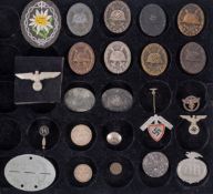 A collection of WWII German Army badges and insignia, comprising eight various would badges,