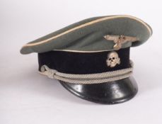 A Waffem SS Officer peaked cap, maker Erel, field grey with white piping and black velvet trim,