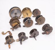 A Wallace & Kerr brass and alloy trout fly reel, together with 8 other brass and alloy trout reels,