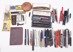 A quantity of various fountain pens, with ink cartridges, in bottle spout,