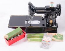 A Singer Model 222K lightweight sewing machine, black with gilt banding,