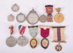 A group of various silver, gilt and enamel association badges and awards,