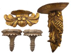 A pair of silvered composition demi-lune wall brackets in early 19th century taste,