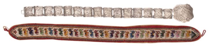 An Indian beadwork belt and an Indonesian pierced white metal belt with buckle the first with a