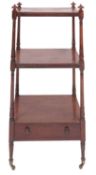 A Regency mahogany three tier etagere, early 19th century; with turned finials at the upper corners,