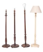 A pair of stained hardwood standard lamps in early 19th century taste, 20th century; with fluted,